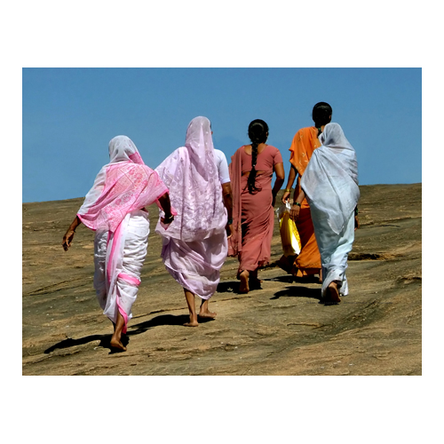 Four women walk up the hill to pray at the Jain Temple. Sravanabelagola, India.